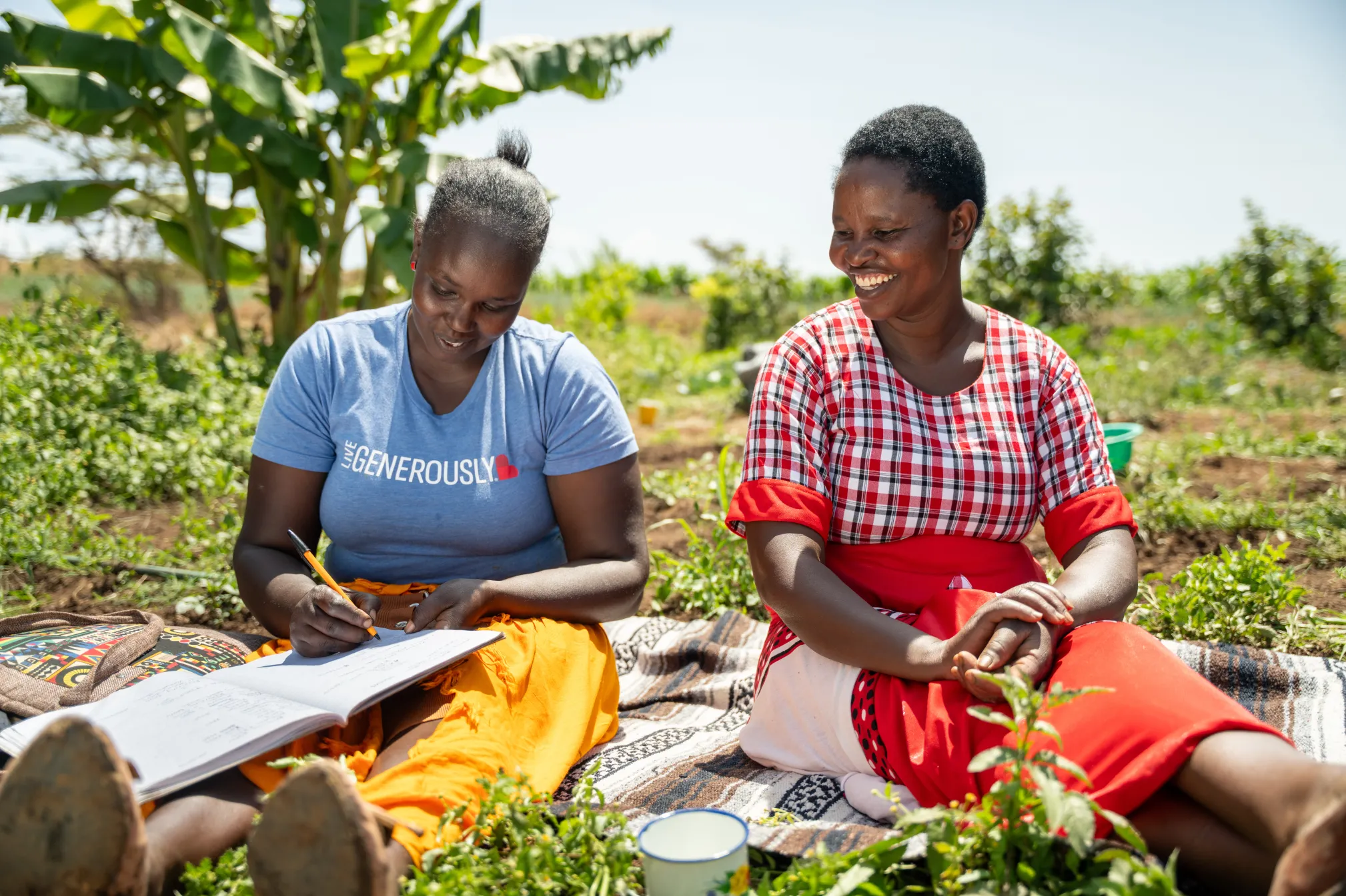 Women farmers in Kenya bookkeeping at their field